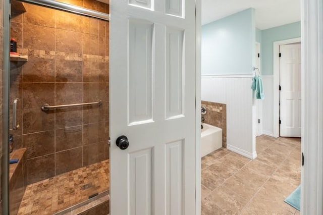 6620 NW 136th St, Kansas City, MO 64164 - bathroom featuring a shower stall, a garden tub, wainscoting, and tile patterned flooring