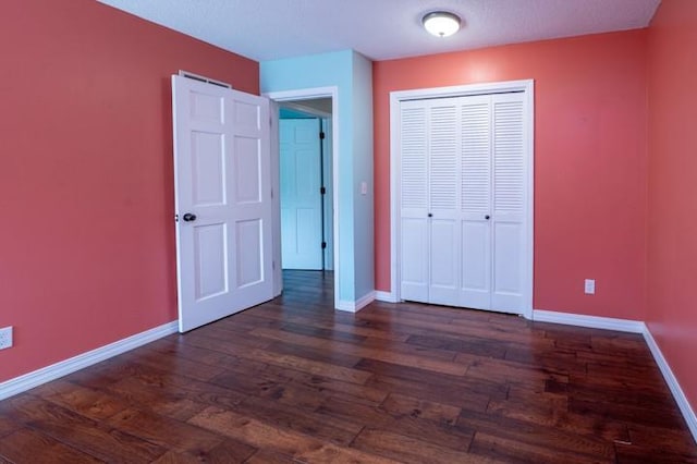 6620 NW 136th St, Kansas City, MO 64164 - unfurnished bedroom featuring a closet, dark wood-style flooring, and baseboards