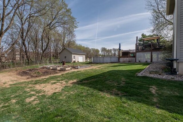 6620 NW 136th St, Kansas City, MO 64164 - view of yard with a deck, fence, an outbuilding, and a vegetable garden