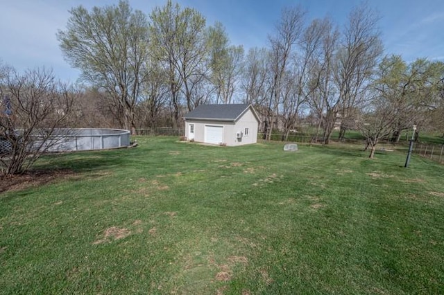 6620 NW 136th St, Kansas City, MO 64164 - view of yard with an outdoor pool, an outbuilding, a garage, and fence