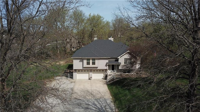6620 NW 136th St, Kansas City, MO 64164 - view of front of house with a garage, roof with shingles, driveway, and a chimney