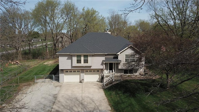 6620 NW 136th St, Kansas City, MO 64164 - split foyer home with a shingled roof, an attached garage, fence, concrete driveway, and a gate