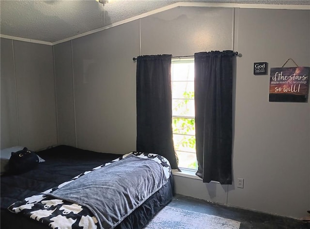 bedroom featuring a textured ceiling and lofted ceiling