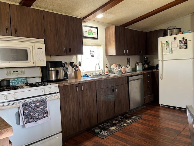 kitchen featuring a sink, white appliances, dark wood finished floors, dark brown cabinets, and a textured ceiling