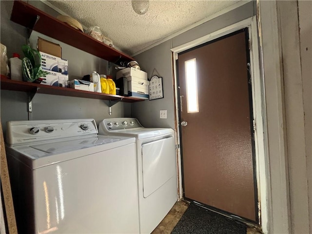 washroom featuring washer and dryer, laundry area, crown molding, and a textured ceiling