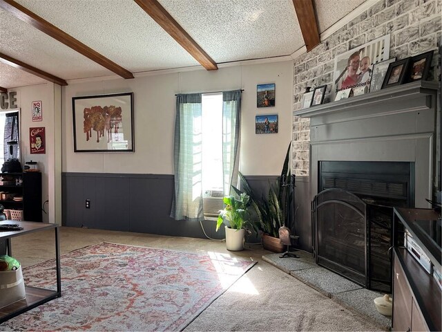 3672 Haynes Hill Rd, Bates City, MO 64011 - living area with beam ceiling, carpet flooring, a textured ceiling, wainscoting, and a fireplace