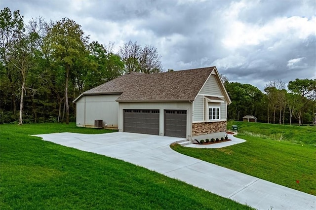 view of home's exterior featuring a lawn, central AC, and a garage