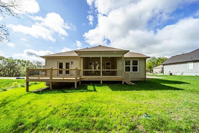back of house with a sunroom, french doors, a yard, and a deck