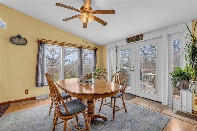 dining room with lofted ceiling, french doors, visible vents, and plenty of natural light