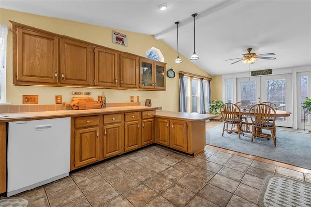 kitchen with white dishwasher, lofted ceiling with beams, brown cabinets, light countertops, and a peninsula