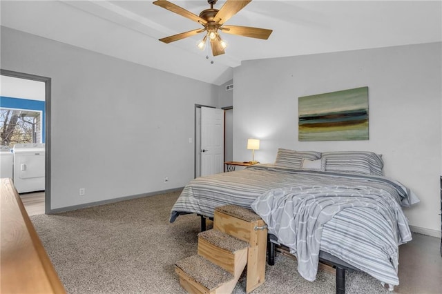 bedroom with ceiling fan, washing machine and clothes dryer, lofted ceiling, and baseboards