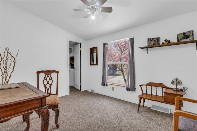 carpeted home office with baseboards, vaulted ceiling, visible vents, and ceiling fan