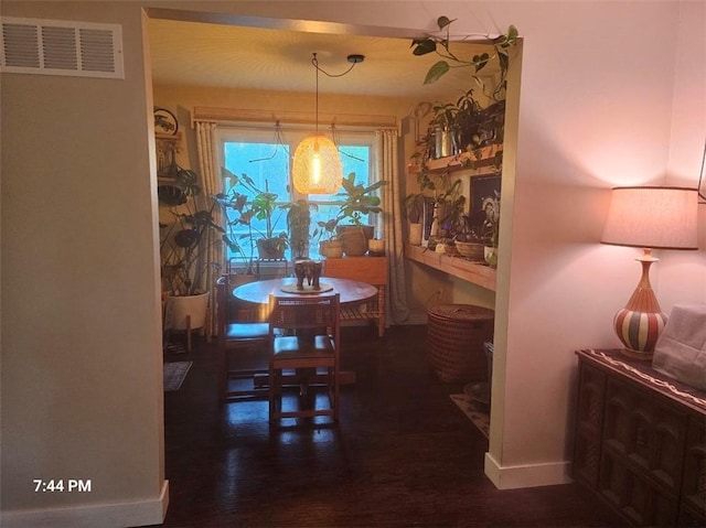 dining room featuring wood finished floors and baseboards