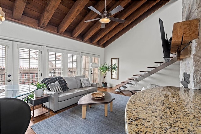living area featuring wood finished floors, beam ceiling, high vaulted ceiling, wood ceiling, and a ceiling fan