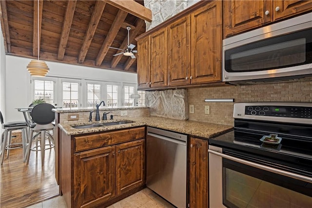 kitchen with ceiling fan, wooden ceiling, tasteful backsplash, a sink, and stainless steel appliances