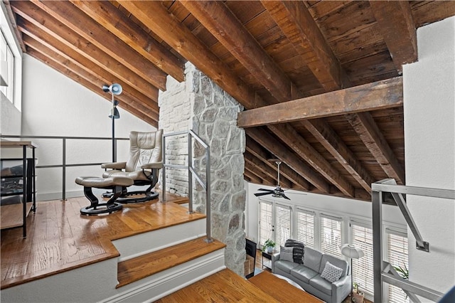 interior space with wood-type flooring, lofted ceiling with beams, wood ceiling, and a ceiling fan
