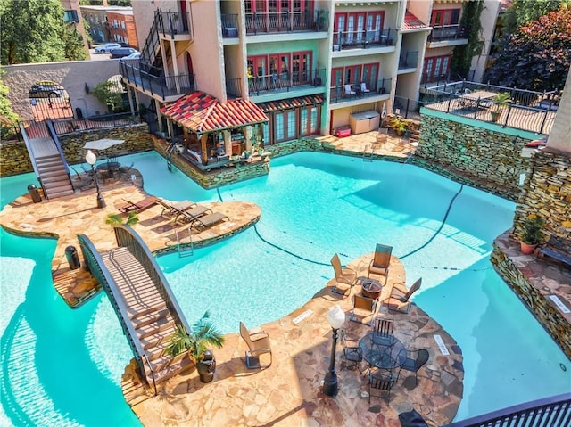 pool with fence and a patio area