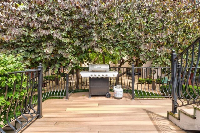 wooden terrace featuring a grill
