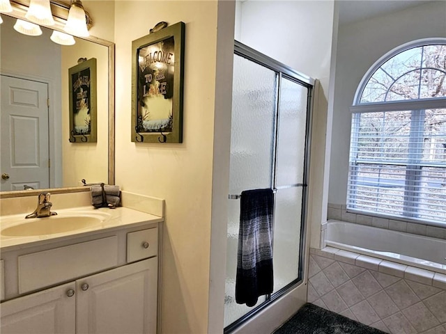 528 W End Cir, Osage Beach, MO 65065 - full bath with healthy amount of natural light, a shower stall, vanity, and a garden tub