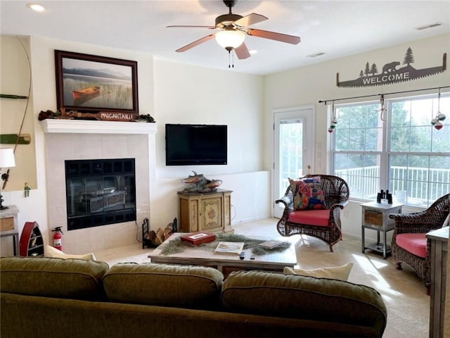 528 W End Cir, Osage Beach, MO 65065 - living area with carpet, a ceiling fan, and a tiled fireplace