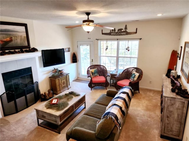 528 W End Cir, Osage Beach, MO 65065 - living room featuring a ceiling fan, healthy amount of natural light, light colored carpet, and a tile fireplace