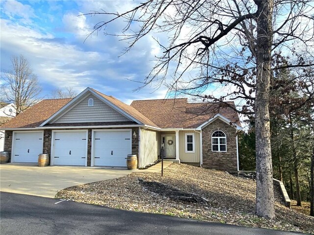 528 W End Cir, Osage Beach, MO 65065 - ranch-style home with stone siding, a garage, driveway, and a shingled roof