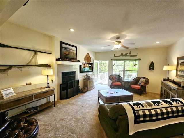 528 W End Cir, Osage Beach, MO 65065 - carpeted living room with a ceiling fan, a fireplace, a textured ceiling, and recessed lighting