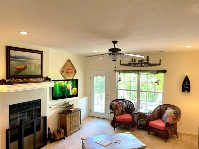 528 W End Cir, Osage Beach, MO 65065 - carpeted living area featuring ceiling fan, a tile fireplace, a textured ceiling, and recessed lighting