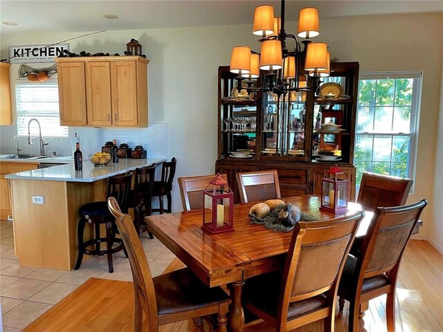 528 W End Cir, Osage Beach, MO 65065 - dining room featuring plenty of natural light, a chandelier, and light tile patterned flooring