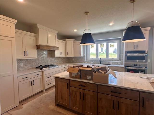 2005 Foxtail Pt, Kearney, MO 64060 - kitchen with backsplash, stainless steel appliances, hanging light fixtures, recessed lighting, and white cabinetry