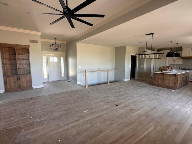 2005 Foxtail Pt, Kearney, MO 64060 - unfurnished living room featuring ornamental molding and light wood-style floors