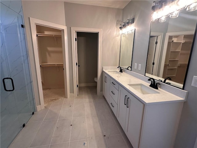 2005 Foxtail Pt, Kearney, MO 64060 - full bathroom with double vanity, a spacious closet, a shower stall, and tile patterned floors