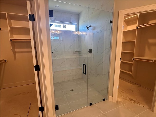 2005 Foxtail Pt, Kearney, MO 64060 - bathroom featuring a spacious closet, a marble finish shower, and tile patterned flooring