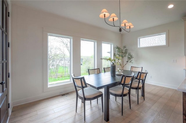 dining space with recessed lighting, a notable chandelier, visible vents, light wood-style flooring, and baseboards