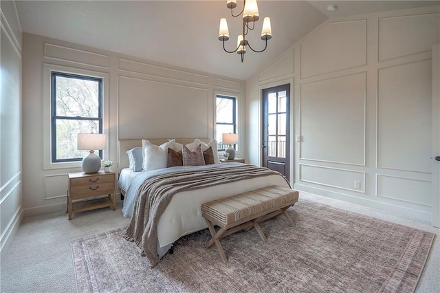 bedroom with light colored carpet, an inviting chandelier, and a decorative wall