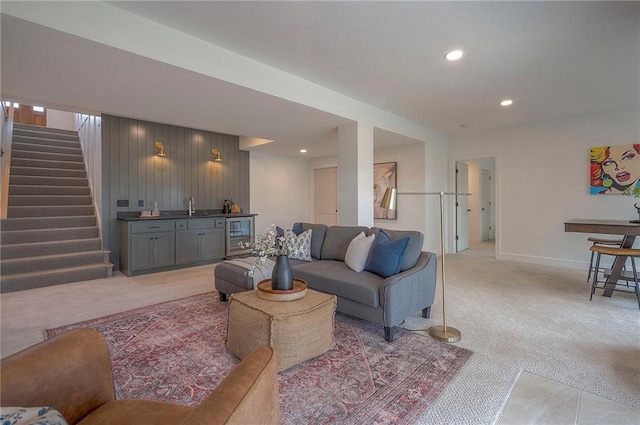 living room featuring light colored carpet, recessed lighting, indoor wet bar, wine cooler, and stairs