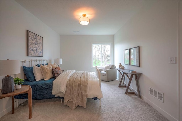 bedroom featuring light colored carpet, visible vents, and baseboards