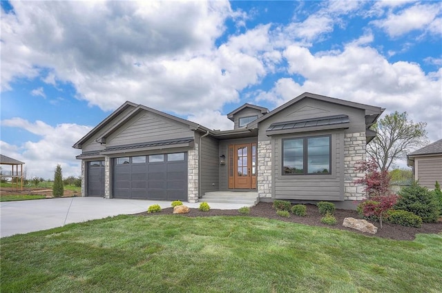 view of front of property with a front lawn, driveway, stone siding, and an attached garage
