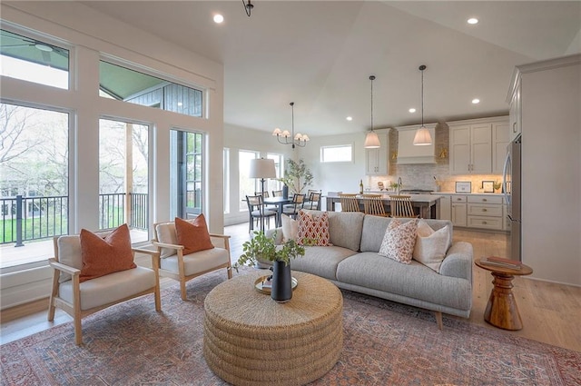 living area with recessed lighting, a chandelier, and wood finished floors