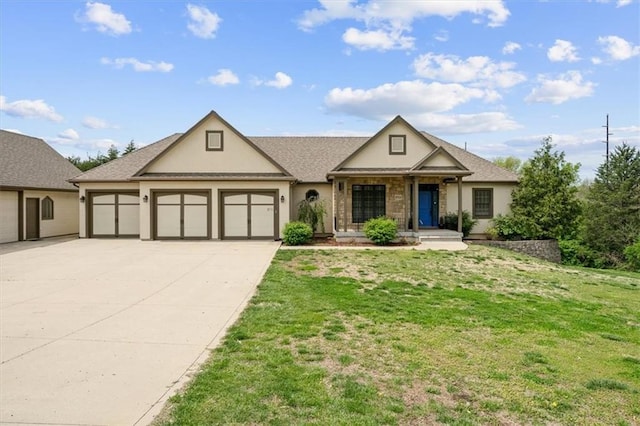 view of front of property with a garage, stucco siding, a front yard, and concrete driveway