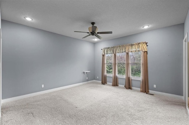 empty room with baseboards, carpet flooring, a textured ceiling, and ceiling fan
