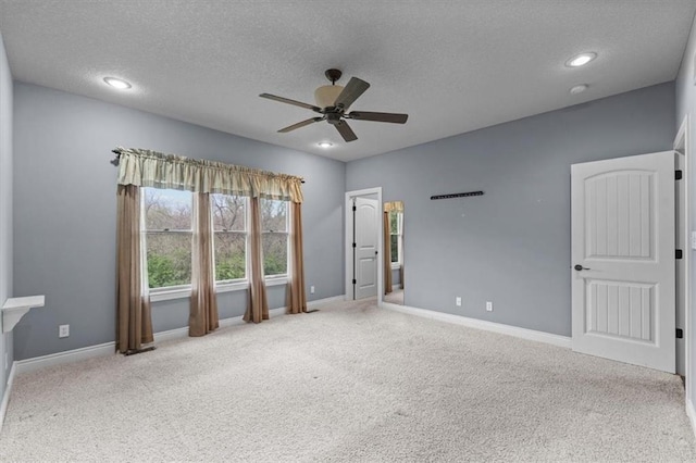 unfurnished bedroom with baseboards, carpet flooring, and a textured ceiling
