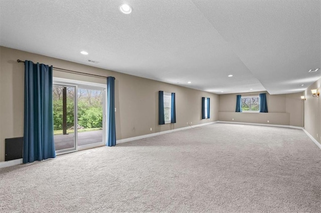 interior space featuring carpet floors, recessed lighting, and a textured ceiling