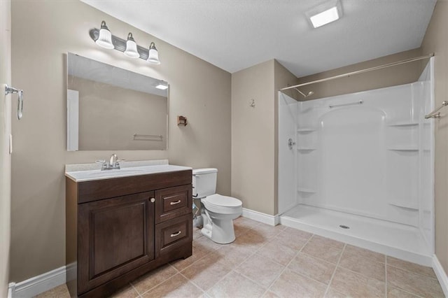 bathroom featuring baseboards, a shower, toilet, and vanity