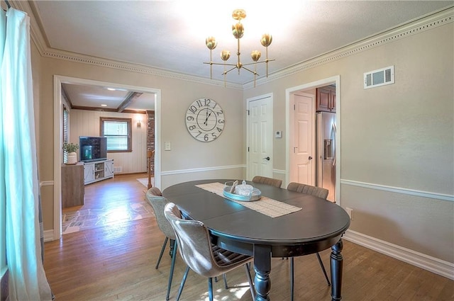 10312 Lamar Ave, Overland Park, KS 66207 - dining area featuring a chandelier, light wood-style flooring, ornamental molding, and baseboards