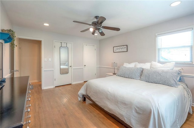 10312 Lamar Ave, Overland Park, KS 66207 - bedroom with recessed lighting, light wood finished floors, two closets, a ceiling fan, and baseboards