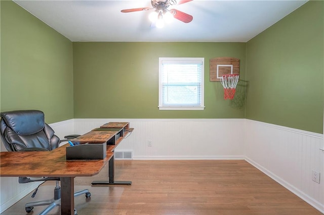 10312 Lamar Ave, Overland Park, KS 66207 - home office featuring wood finished floors, a wainscoted wall, and a ceiling fan
