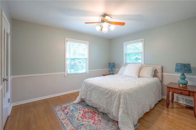 10312 Lamar Ave, Overland Park, KS 66207 - bedroom with light wood-style flooring, baseboards, and ceiling fan