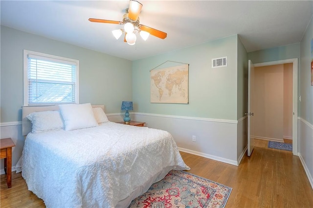 10312 Lamar Ave, Overland Park, KS 66207 - bedroom with wood finished floors, baseboards, and ceiling fan