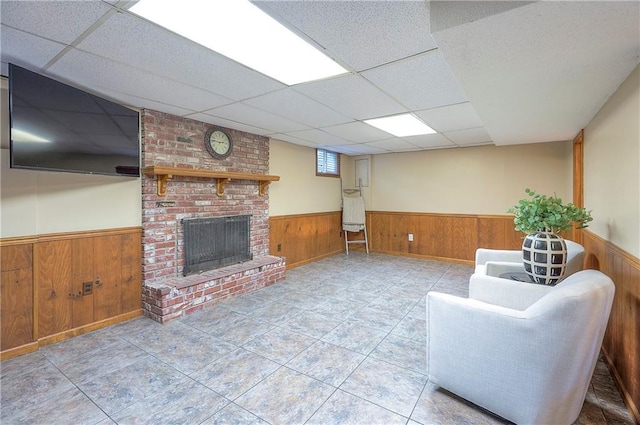 10312 Lamar Ave, Overland Park, KS 66207 - living area with a wainscoted wall, wood walls, a paneled ceiling, and a brick fireplace